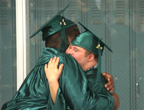 PRIDE students embrace at graduation. 