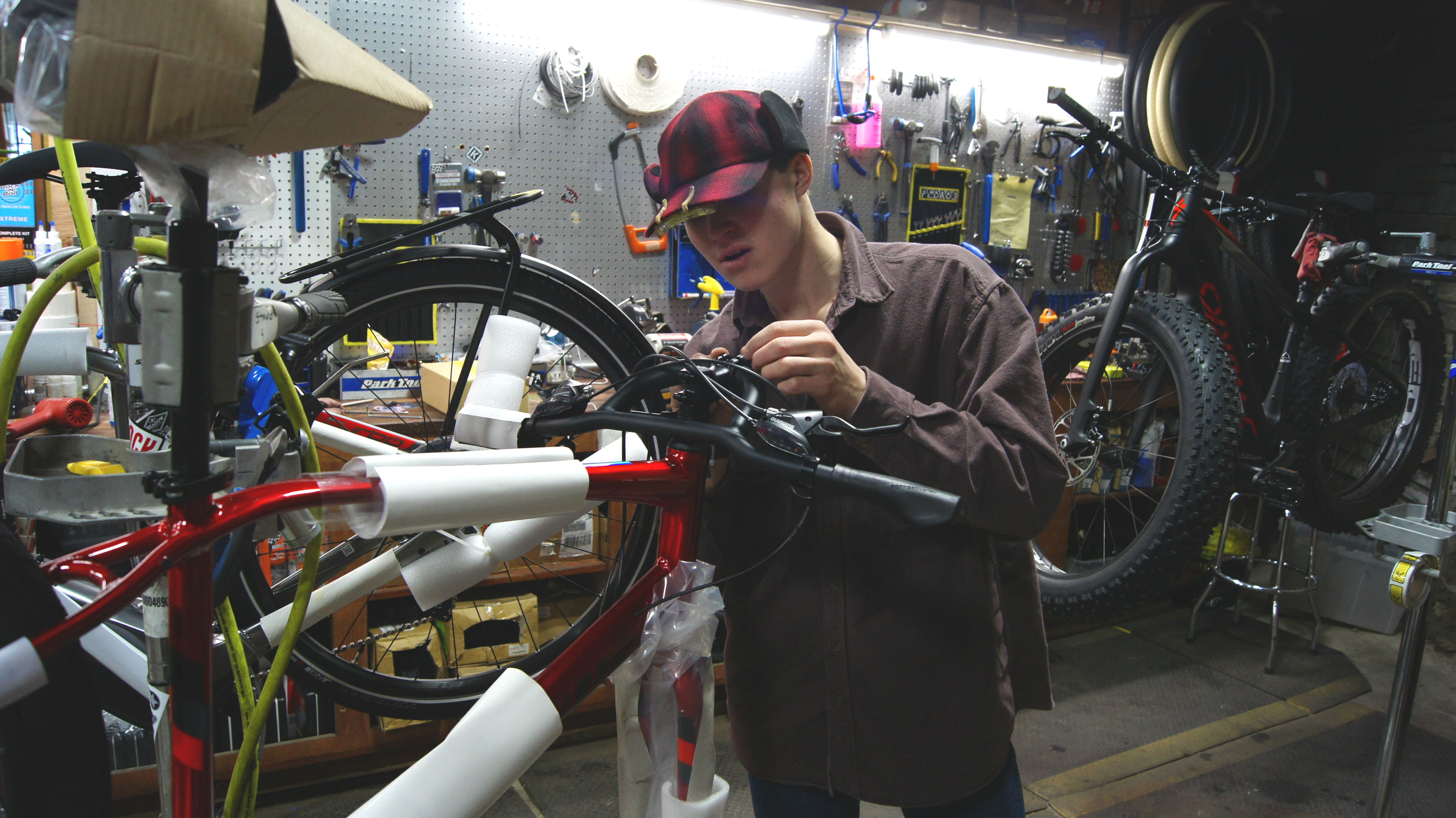 A PRIDE student works on a bicycle. 