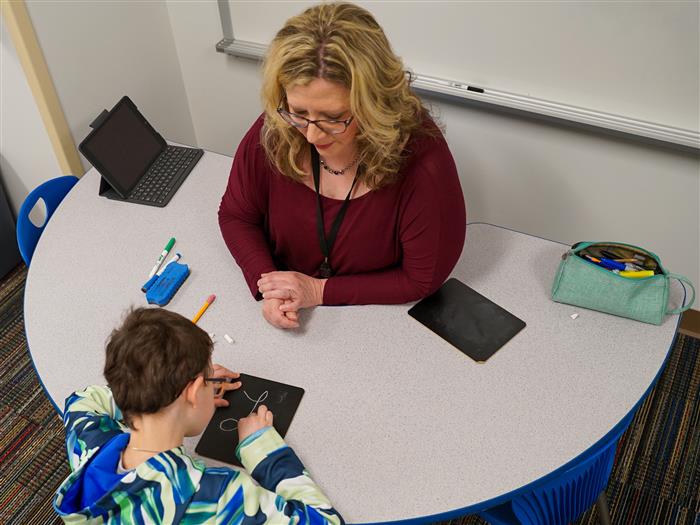 AIU Occupational Therapist Darla Donnell practices handwriting with students at Shaler Area School District.
