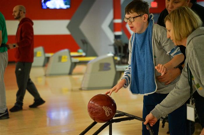 Student using a bowling aid during the 2023 AIU Bowling Tournament